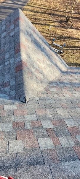 Storm-damaged shingles found during a roof evaluation